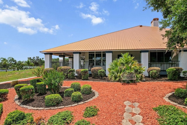 3773 E Lake Todd Dr, Hernando, FL 34442 - rear view of property featuring metal roof, a chimney, and a porch