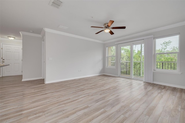 5041 Royal Palms Way Unit 203, New Port Richey, FL 34652 - unfurnished room featuring ceiling fan, healthy amount of natural light, light wood-style flooring, baseboards, and crown molding