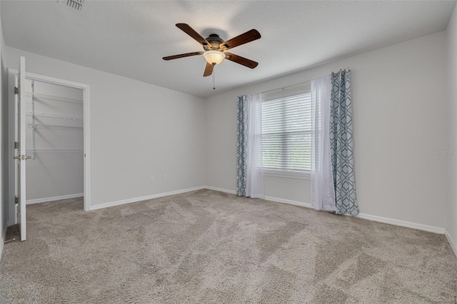 5041 Royal Palms Way Unit 203, New Port Richey, FL 34652 - carpeted spare room with a ceiling fan and baseboards