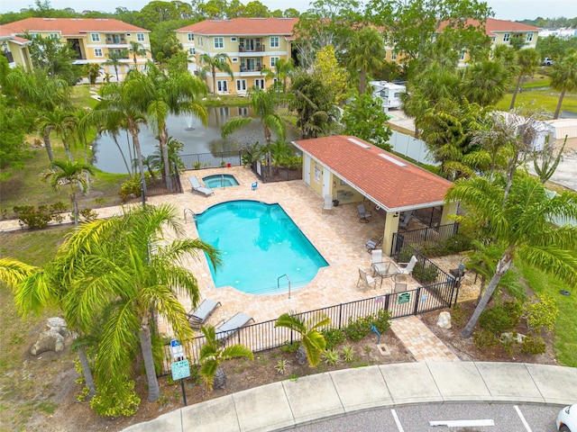 5041 Royal Palms Way Unit 203, New Port Richey, FL 34652 - community pool with a hot tub, a patio area, a residential view, and a water view