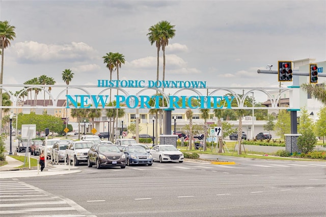 5041 Royal Palms Way Unit 203, New Port Richey, FL 34652 - view of asphalt road with traffic lights, sidewalks, traffic signs, curbs, and street lighting