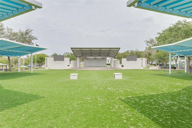 5041 Royal Palms Way Unit 203, New Port Richey, FL 34652 - view of green lawn featuring a detached carport and a pergola