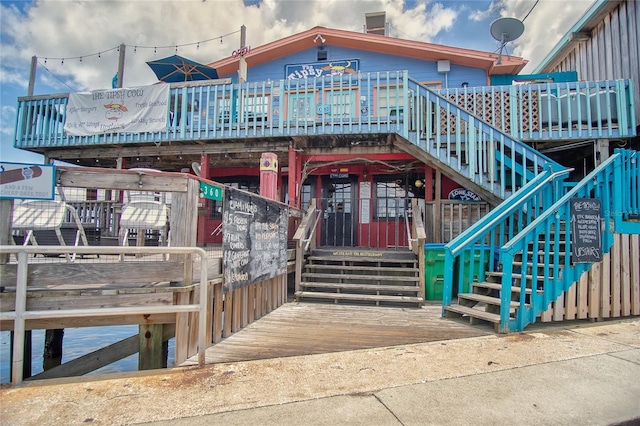 1226 Hawthorne Ave, Cedar Key, FL 32625 - rear view of house featuring stairway