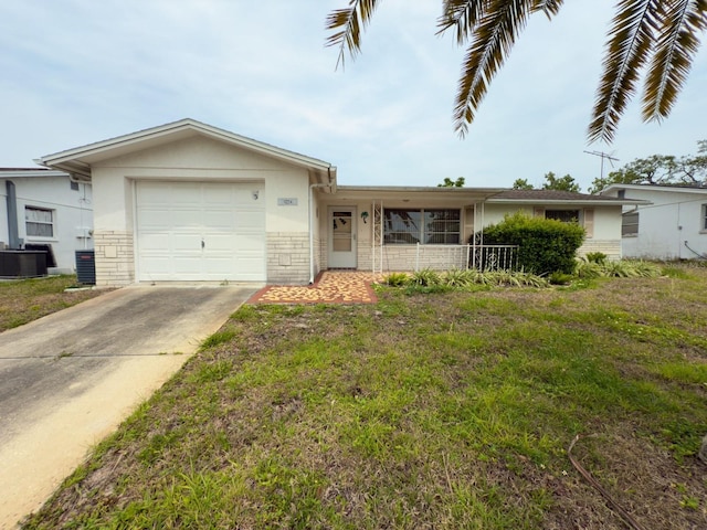 ranch-style house with central air condition unit, driveway, an attached garage, a front lawn, and stucco siding