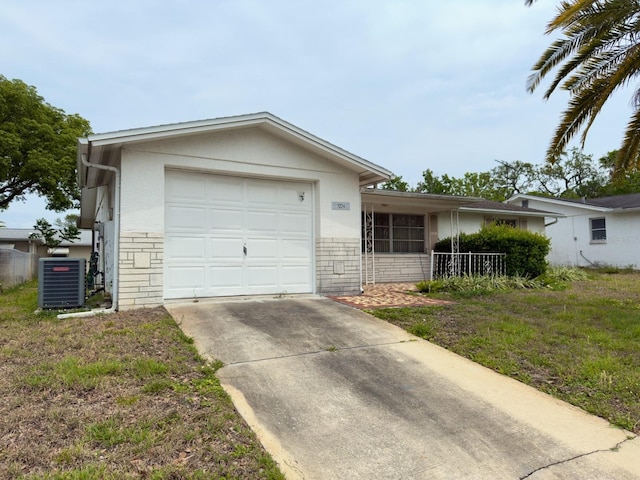 ranch-style house with central AC unit, concrete driveway, a garage, fence, and stucco siding