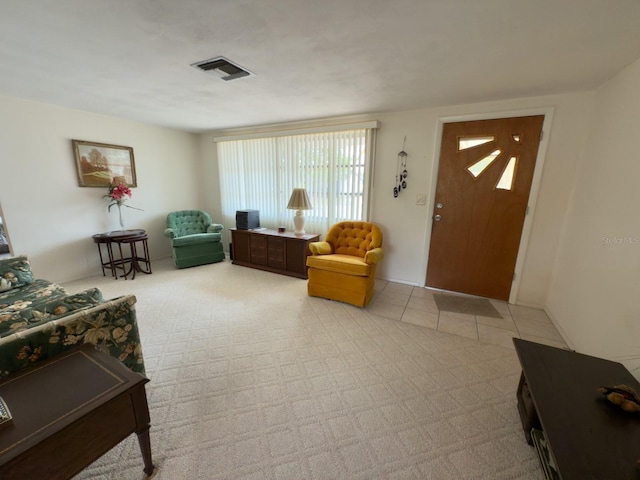 living area with light colored carpet and light tile patterned floors