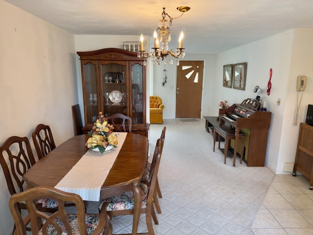 dining area with a chandelier and light tile patterned flooring