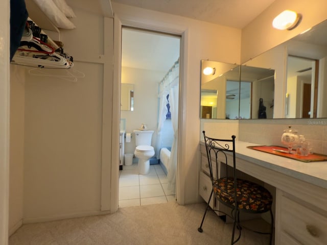 full bathroom with toilet, decorative backsplash, vanity, tile patterned flooring, and a shower