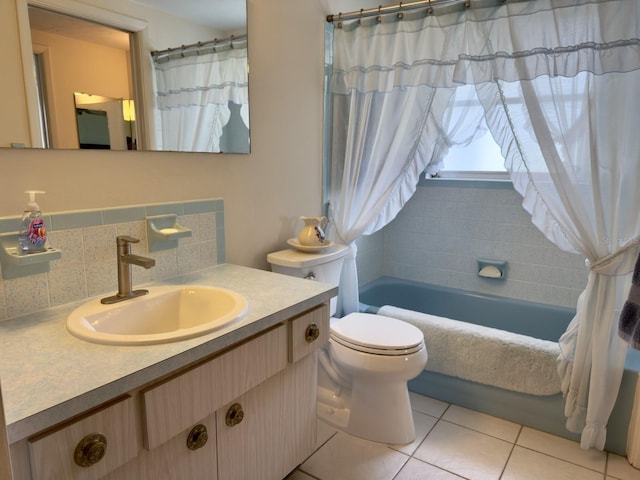 bathroom featuring tile patterned flooring, toilet, decorative backsplash, and vanity