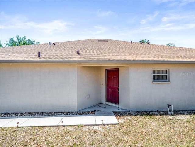 3885 Crossline Dr, Spring Hill, FL 34609 - back of house with a shingled roof and stucco siding