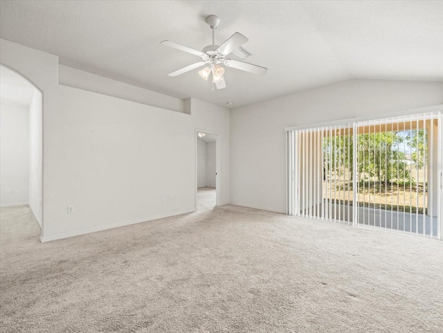 3885 Crossline Dr, Spring Hill, FL 34609 - carpeted empty room with arched walkways, ceiling fan, and lofted ceiling