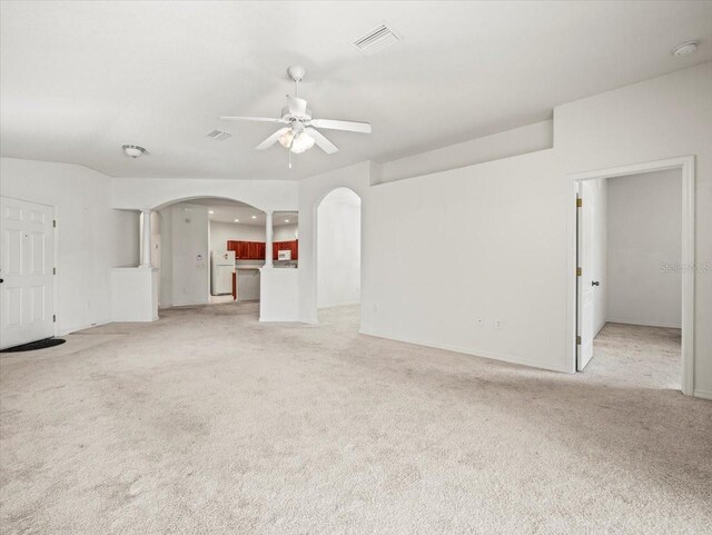 3885 Crossline Dr, Spring Hill, FL 34609 - unfurnished living room with arched walkways, ceiling fan, light colored carpet, baseboards, and recessed lighting