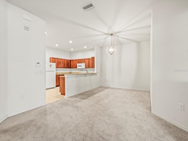 3885 Crossline Dr, Spring Hill, FL 34609 - kitchen featuring white appliances, light colored carpet, recessed lighting, a kitchen breakfast bar, and a peninsula