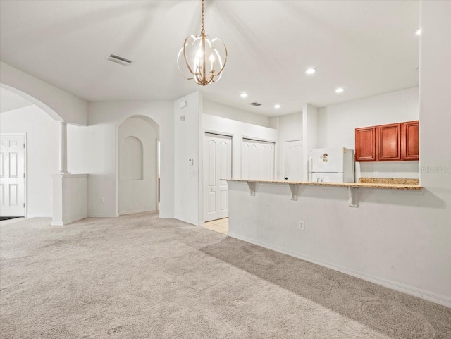 3885 Crossline Dr, Spring Hill, FL 34609 - unfurnished living room with arched walkways, light colored carpet, baseboards, and recessed lighting