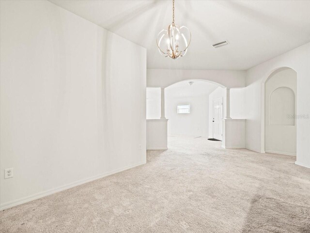 3885 Crossline Dr, Spring Hill, FL 34609 - carpeted spare room with arched walkways, a chandelier, and baseboards