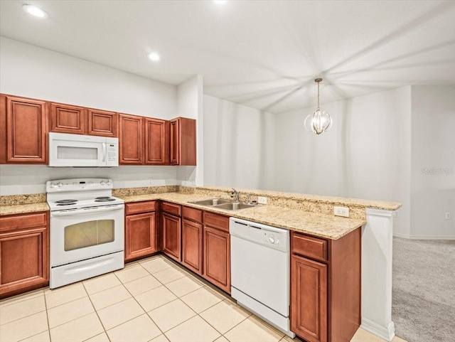 3885 Crossline Dr, Spring Hill, FL 34609 - kitchen with white appliances, a sink, a peninsula, light stone counters, and recessed lighting