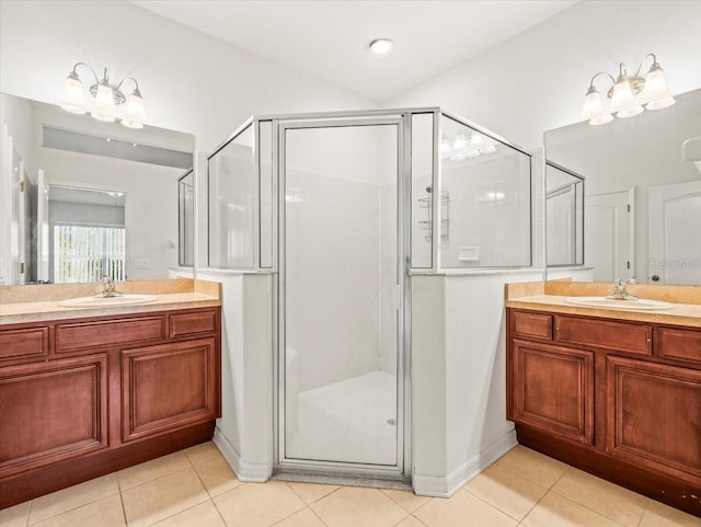 3885 Crossline Dr, Spring Hill, FL 34609 - bathroom with a stall shower, two vanities, tile patterned flooring, and baseboards