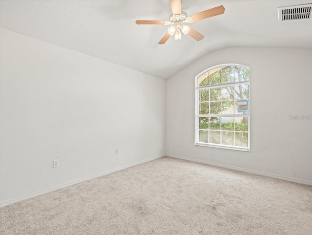 3885 Crossline Dr, Spring Hill, FL 34609 - spare room featuring lofted ceiling, carpet flooring, ceiling fan, and baseboards