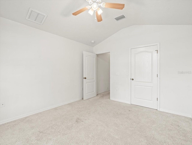 3885 Crossline Dr, Spring Hill, FL 34609 - unfurnished room with vaulted ceiling, light colored carpet, a ceiling fan, and baseboards