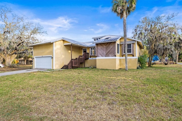 view of front of home with metal roof, a front lawn, and driveway