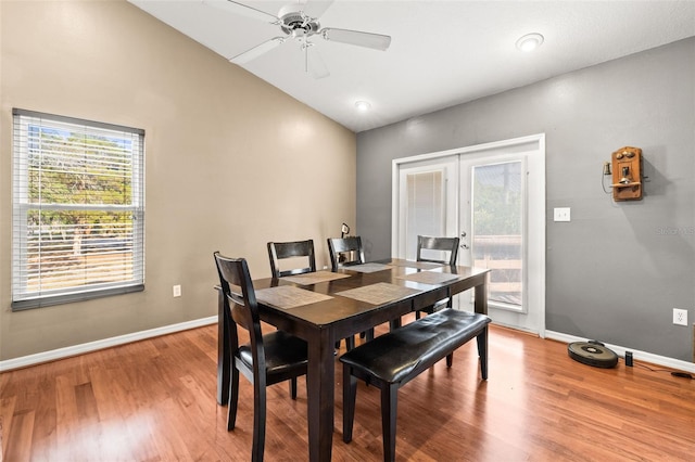 dining area featuring french doors, vaulted ceiling, baseboards, wood finished floors, and a ceiling fan