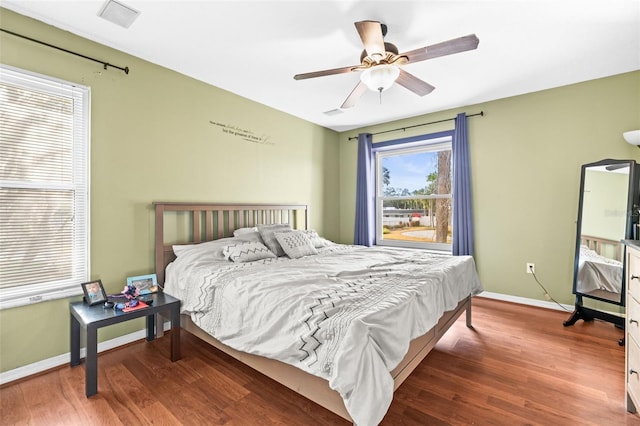 bedroom with wood finished floors, baseboards, and ceiling fan