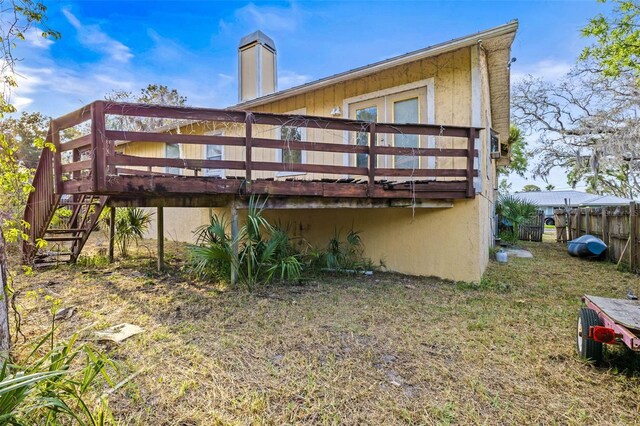 rear view of house with a deck and stairs