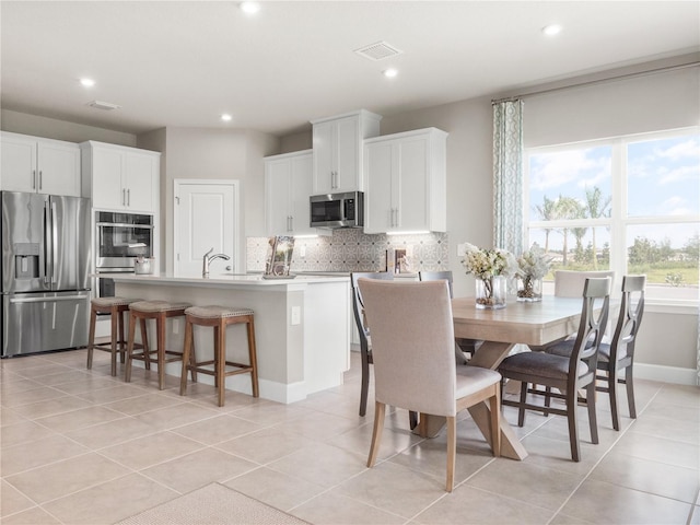 2193 Aibonito Cir, Clermont, FL 34711 - dining area featuring recessed lighting, light tile patterned floors, and baseboards