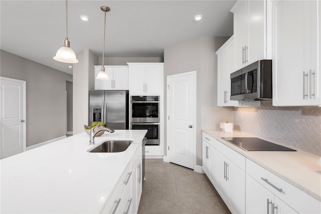2193 Aibonito Cir, Clermont, FL 34711 - kitchen featuring appliances with stainless steel finishes, a sink, backsplash, pendant lighting, and light countertops