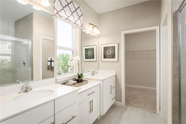 2193 Aibonito Cir, Clermont, FL 34711 - bathroom featuring a stall shower, double vanity, tile patterned flooring, and a walk in closet