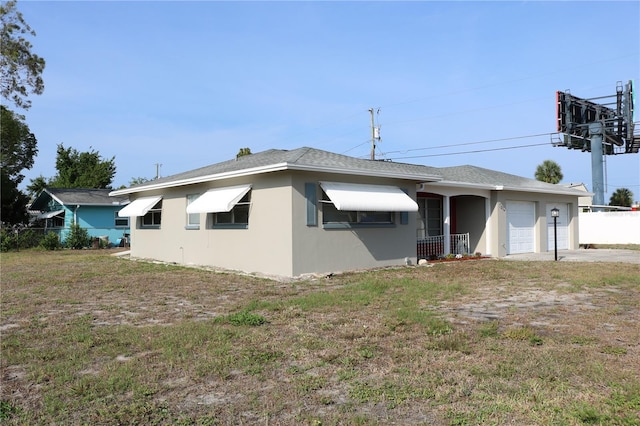 view of front of house with an attached garage, concrete driveway, and stucco siding