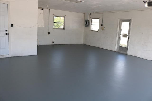 garage featuring a garage door opener and electric panel