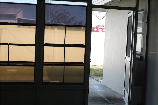 doorway with unfinished concrete floors