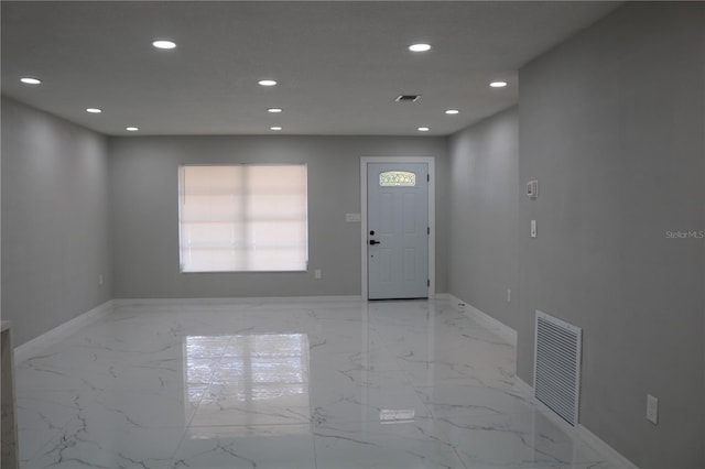 entrance foyer with recessed lighting, baseboards, and light marble finish floors