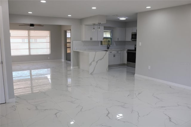 kitchen featuring stainless steel appliances, a sink, light marble finish flooring, baseboards, and recessed lighting