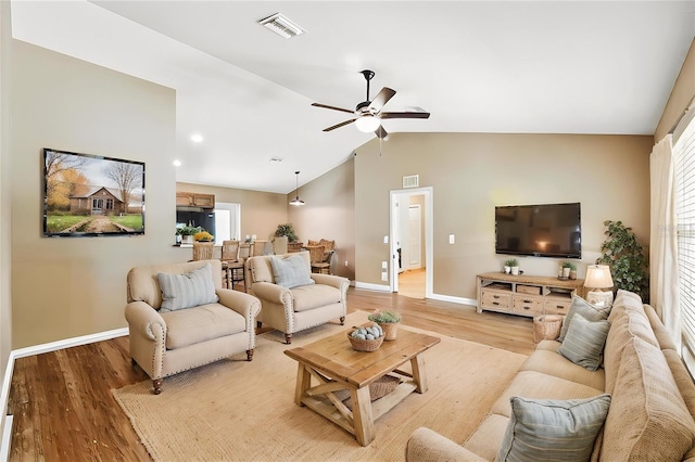 1161 Crk 443, Lake Panasoffkee, FL 33538 - living area with baseboards, ceiling fan, light wood-style floors, and vaulted ceiling