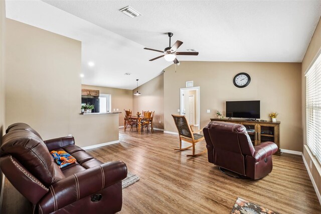 1161 Crk 443, Lake Panasoffkee, FL 33538 - living area with vaulted ceiling, ceiling fan, light wood-type flooring, and baseboards