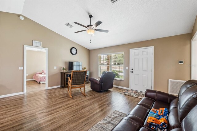 1161 Crk 443, Lake Panasoffkee, FL 33538 - living room with a ceiling fan, wood finished floors, vaulted ceiling, and baseboards