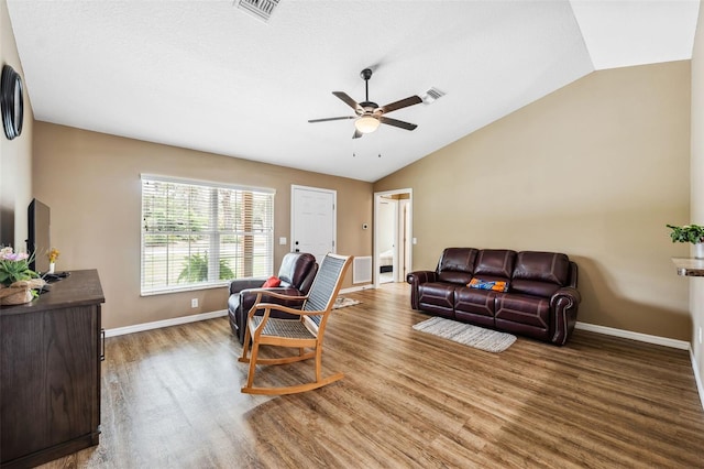 1161 Crk 443, Lake Panasoffkee, FL 33538 - living room featuring vaulted ceiling, a ceiling fan, wood finished floors, and baseboards