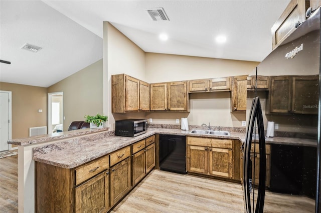 1161 Crk 443, Lake Panasoffkee, FL 33538 - kitchen featuring stainless steel microwave, black dishwasher, a sink, light wood-style floors, and a peninsula