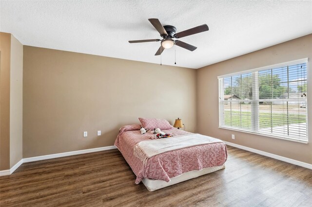 1161 Crk 443, Lake Panasoffkee, FL 33538 - bedroom featuring wood finished floors, baseboards, a ceiling fan, and a textured ceiling