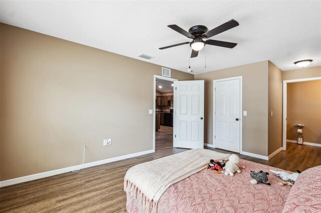 1161 Crk 443, Lake Panasoffkee, FL 33538 - bedroom featuring wood finished floors, baseboards, and a ceiling fan