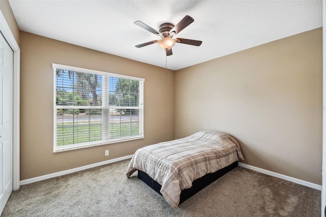 1161 Crk 443, Lake Panasoffkee, FL 33538 - carpeted bedroom with baseboards, a ceiling fan, and a closet