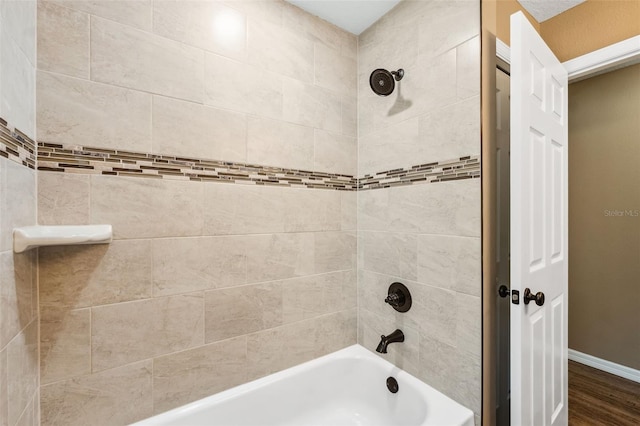 1161 Crk 443, Lake Panasoffkee, FL 33538 - bathroom featuring shower / washtub combination, baseboards, and wood finished floors