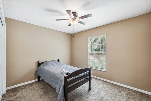 1161 Crk 443, Lake Panasoffkee, FL 33538 - carpeted bedroom with baseboards and ceiling fan