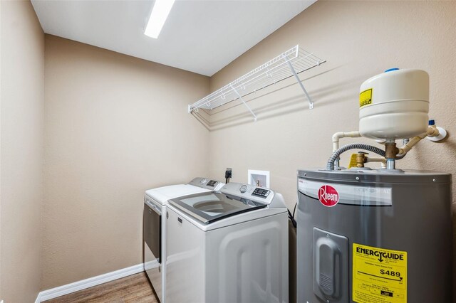 1161 Crk 443, Lake Panasoffkee, FL 33538 - laundry area with water heater, washing machine and clothes dryer, wood finished floors, and baseboards