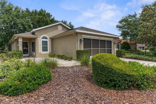 261 Rochester St, Spring Hill, FL 34609 - view of side of home featuring stucco siding, a garage, and concrete driveway
