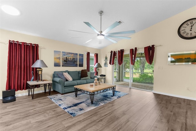 261 Rochester St, Spring Hill, FL 34609 - living room featuring wood finished floors, ceiling fan, vaulted ceiling, and baseboards