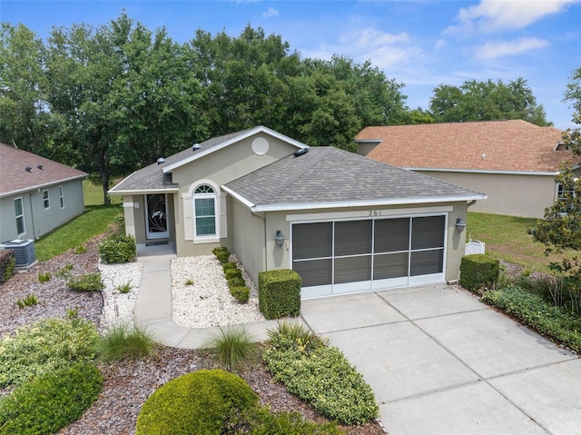 261 Rochester St, Spring Hill, FL 34609 - ranch-style house with an attached garage, stucco siding, roof with shingles, concrete driveway, and central AC