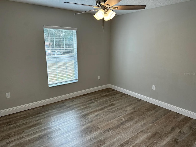 9252 N Agatha Dr, Citrus Springs, FL 34434 - unfurnished room featuring dark wood-type flooring, a ceiling fan, and baseboards